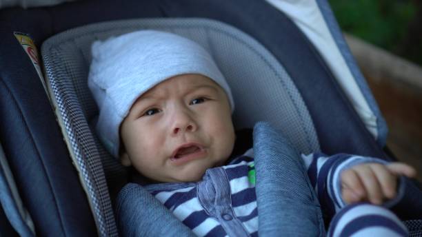istock A newborn baby is crying while lying in a stroller. The child is unwell. 1407000346