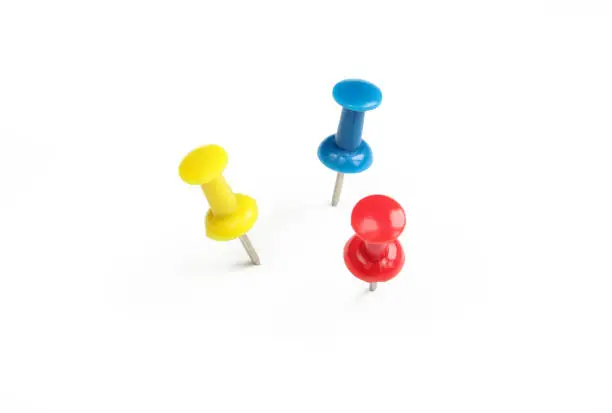 Red,yellow and blue push pin isolated on white background