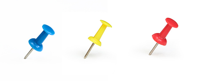 Red,yellow and blue push pin isolated on white background