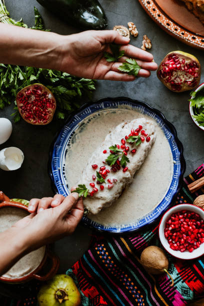 mexican woman cooking chiles en nogada recipe with poblano chili and ingredients, traditional dish in puebla mexico - vegetable pepper food chili pepper imagens e fotografias de stock