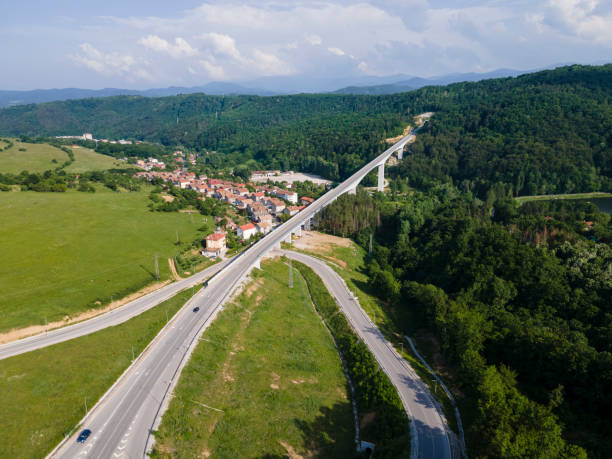 istock Elevated highway road passing over suburb area, aerial view. 1407007200
