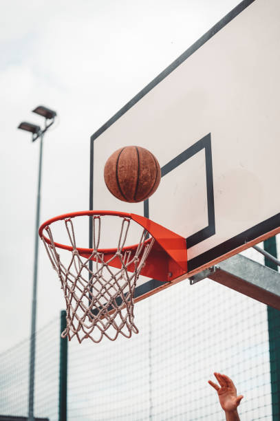 istock Basketball falling into the hoop 1407007225