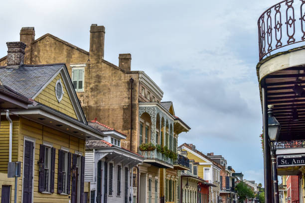 New Orleans, USA French quarter with wrought cast iron balcony of building in traditional architecture with potted plants decoration in Louisiana famous city