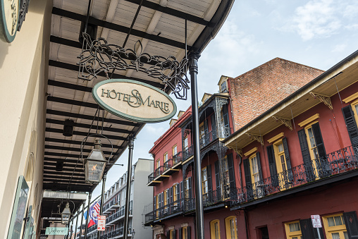 New Orleans, LA, USA - June 27, 2022: View of the traditional and historic architecture of the French Quarter in New Orleans. The French Quarter, also known as the Vieux Carré, is the oldest neighborhood in the city of New Orleans.