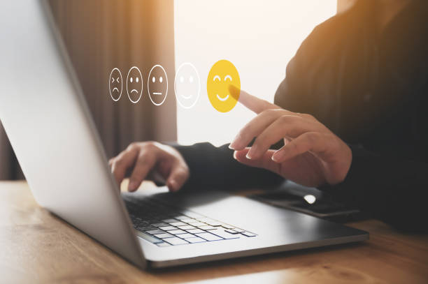 istock Customer service experience and business satisfaction survey. Male hand using computer laptop choose face smile 1407021616