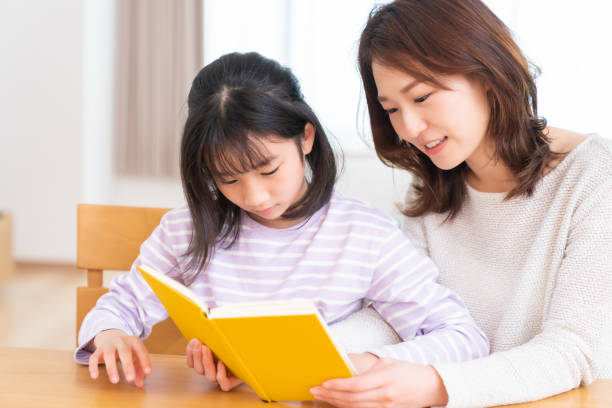 istock parent and daughter who reads a book 1407022390