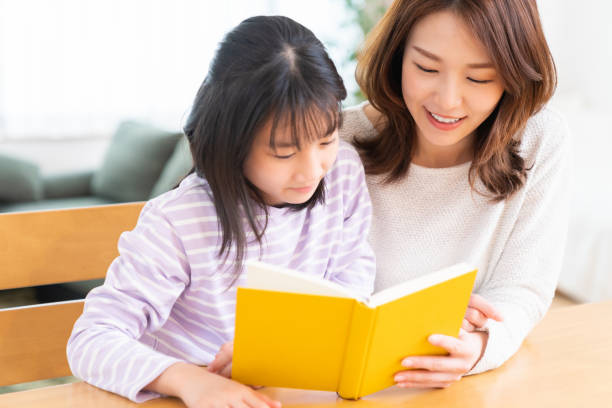 istock parent and daughter who reads a book 1407022424