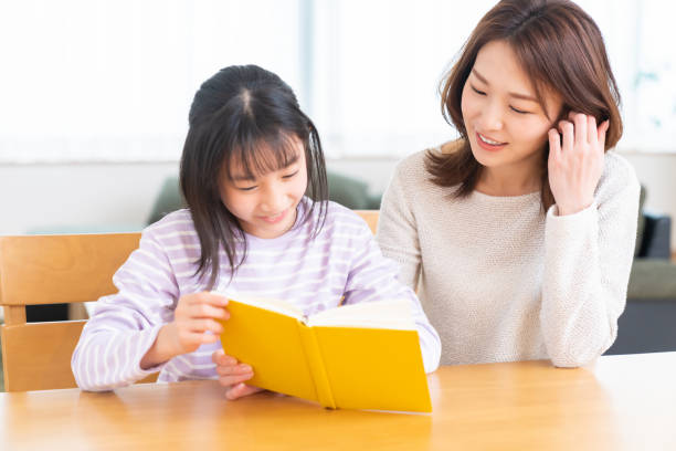 istock parent and daughter who reads a book 1407022465