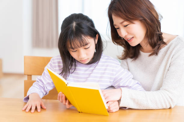 istock parent and daughter who reads a book 1407022489