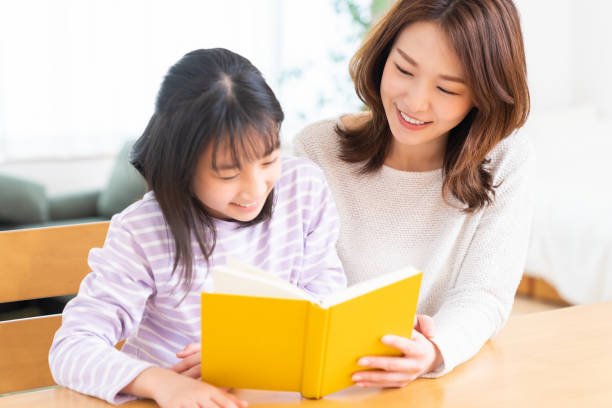 istock parent and daughter who reads a book 1407022574