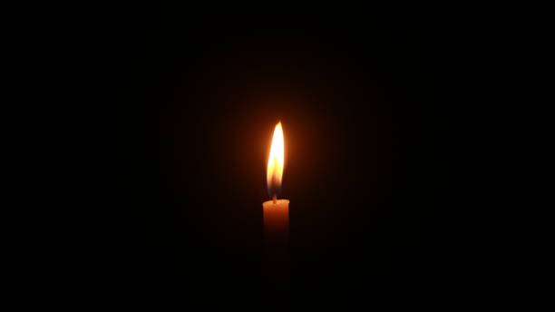 istock Candle light burning brightly in the black background. 1407025495