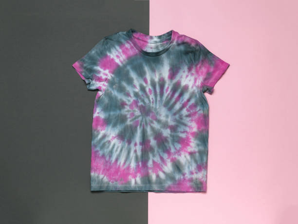 istock Gray-red tie dye T-shirt on a gray-red background. Flat lay. 1407028814