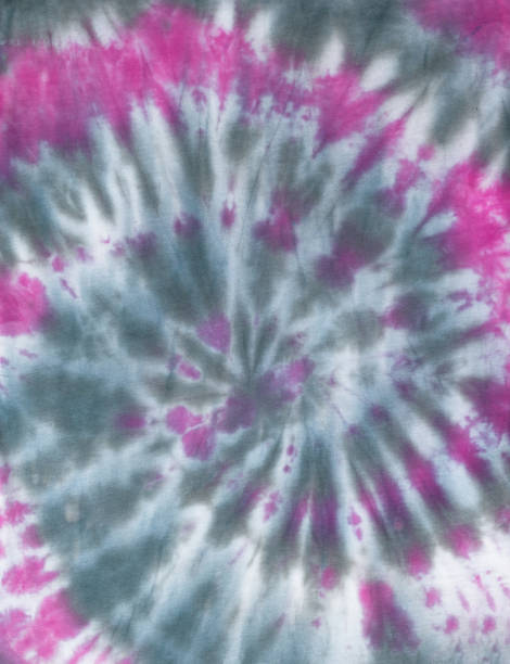 istock Spiral pattern in tie dye style made by hand on white fabric in gray-red color. Flat lay. 1407028818