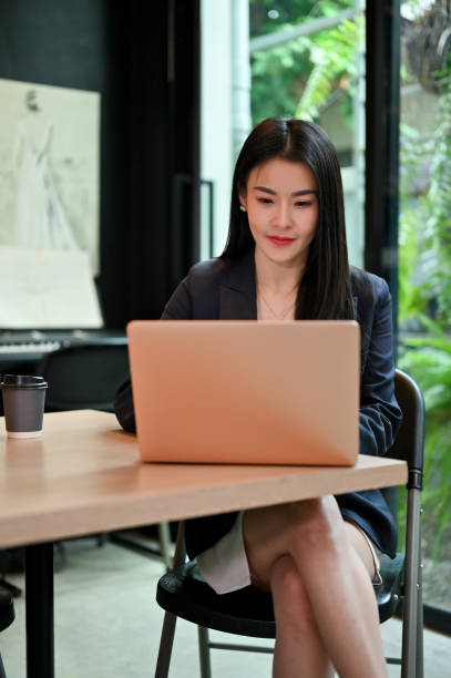 istock Confident Asian businesswoman working on her task on laptop. 1407029064