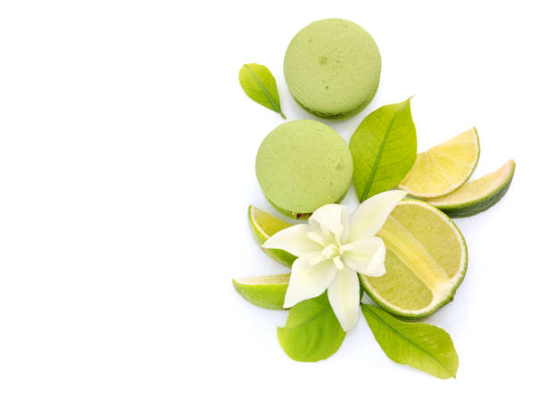 istock Juicy lemon fruit and green macarons on a white background 1407030752