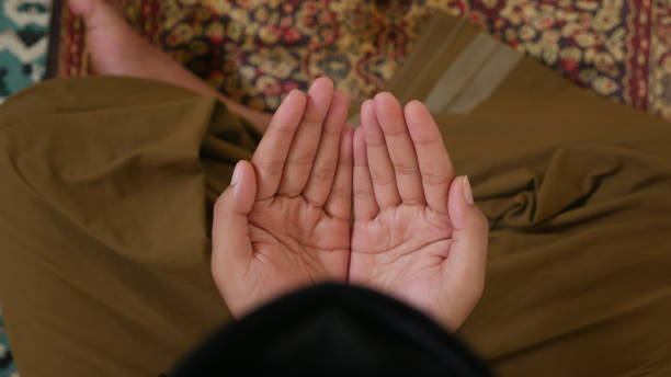 istock Raise your hand to pray 1407032844