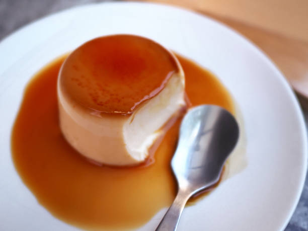 istock Delicious vanilla custard in caramel sauce with spoon 1407034804
