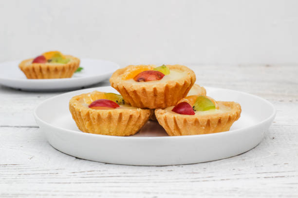 istock Small fruit pia cake on a textured white background. Kue Pia Buah. 1407035727