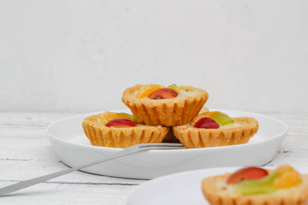 istock Small fruit pia cake on a textured white background. Kue Pia Buah. 1407035758