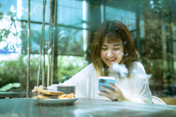 istock Professional woman using smart phone while having breakfast at home. 1407036695