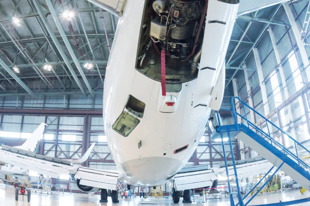 istock White passenger aircraft in the hangar. Airplane under maintenance 1407036856