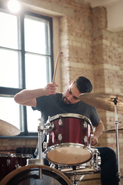 istock Drummer playing drums sitting at drum kit 1407038841