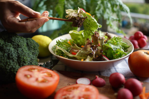 istock Woman eating mixed salad 1407040588