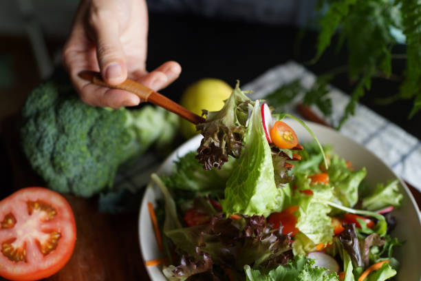 istock Woman eating mixed salad 1407044832