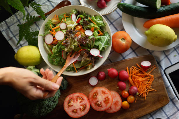 istock Woman eating mixed salad 1407045035