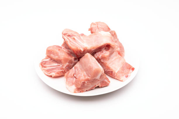 istock Raw Pork Bone Spine in white dish isolated on white 1407045428