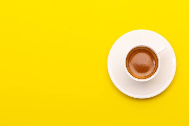 istock Top view espresso coffee in white cup on yellow 1407046391
