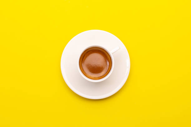 istock Top view espresso coffee in white cup on yellow 1407046401