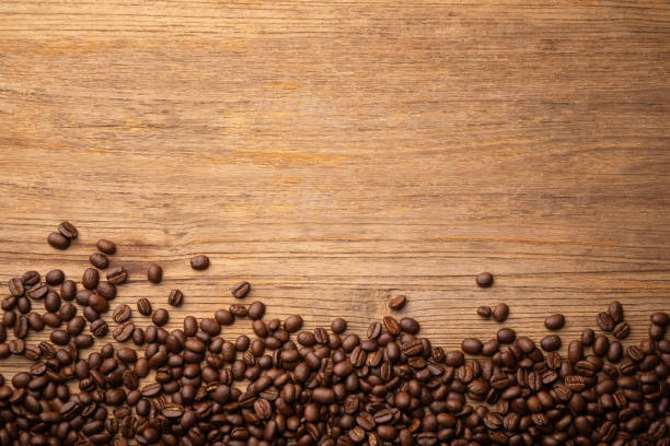 istock Coffee bean on wooden table background. Food and beverage concept 1407046678