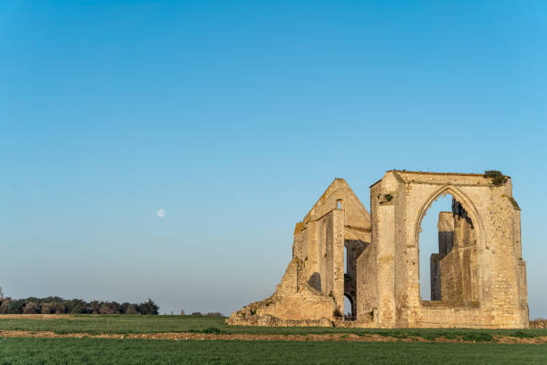 istock panorama of chateliers abbey with moon in the sky 1407048230