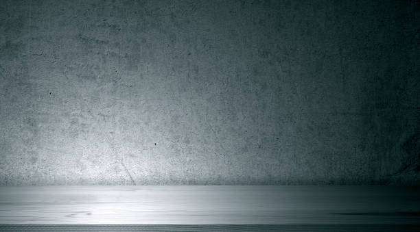 istock Light by spotlight on cement concrete wall and wooden shelf or floor 1407049114