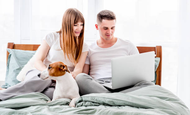 istock Couple in the bed with gadgets 1407049807