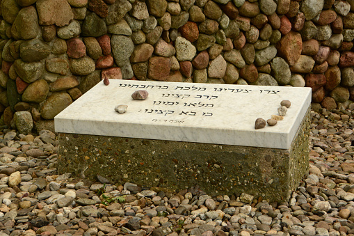 Westerbork-Netherlands; 26-june, 2022 : During world war ii was this camp a transit camp.  to visit without entrance fee. A memorial stone with hebrew text from the bible with stones placed on the top for love and tribute. Memorial and silence place.