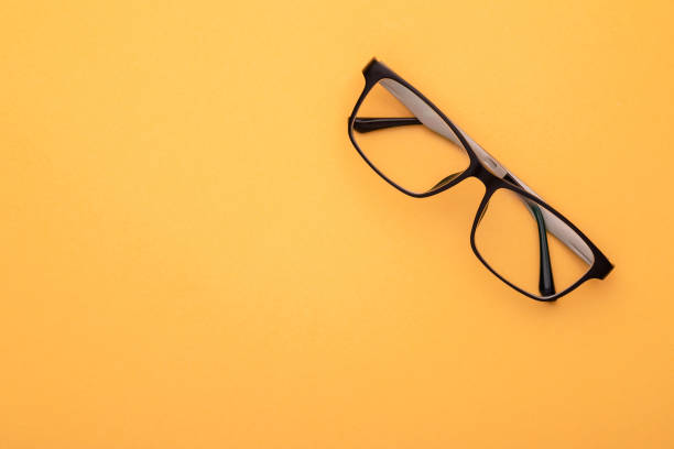 istock New eyeglasses on yellow background. Copy space for text or design 1407052629