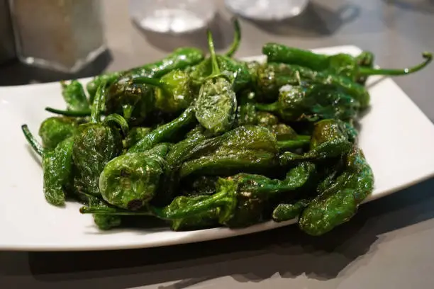 Photo of Close up Blistered Padron peppers (Pimientos de Padrón)