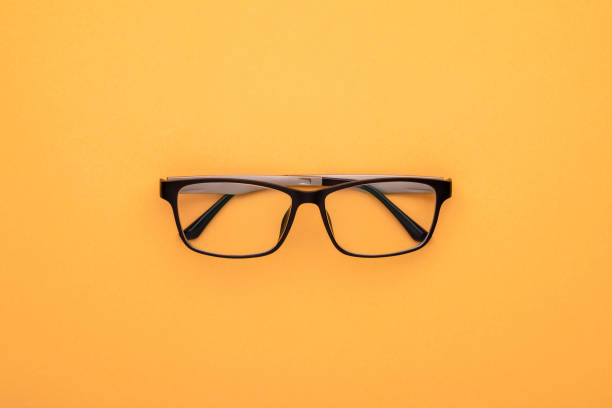 istock New eyeglasses on yellow background. Copy space for text or design 1407053564