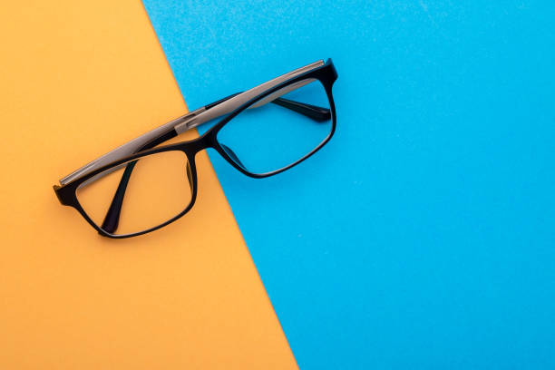 istock New eyeglasses on yellow background. Copy space for text or design 1407053597