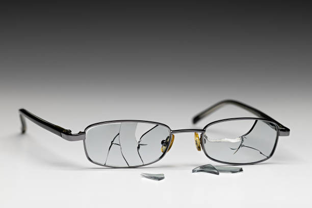 Closeup of black horned rim glasses with white fabric tape holding the bridge together. Qinessential nerd gear!