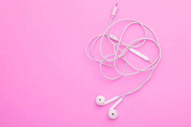 istock White tangle earphone on pink background. Copy space for text or design 1407054629