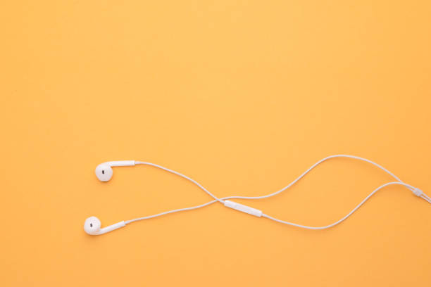 istock White earphone on yellow background. Copy space for text or design 1407054683
