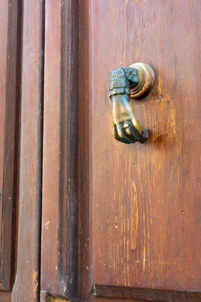 istock Exagonal Clapper on Green Painted Wood Door 1407055388