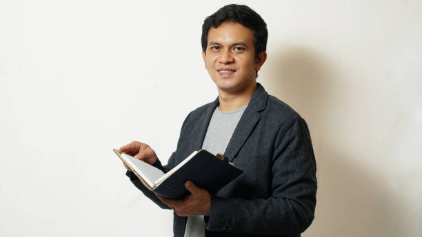istock Portrait of a Student Holding a Book 1407055957