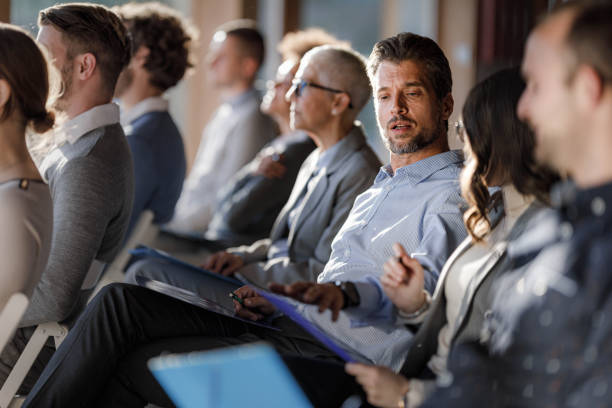 istock Businessman talking to his colleague on a seminar. 1407060190