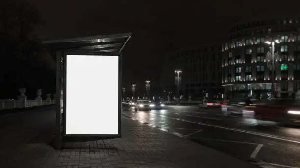 Photo of Vertically white empty lightbox on side of bus stop