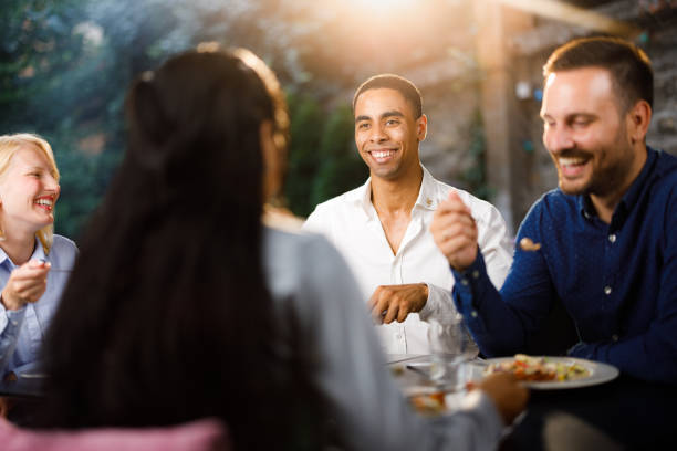 istock Group of happy colleagues talking while enjoying in lunch at a restaurant. 1407061862