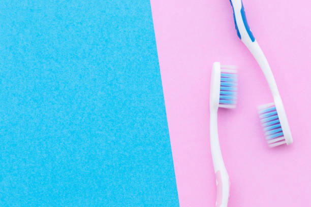 istock New pink and blue toothbrush on pink background with copy space for text or design. 1407062060